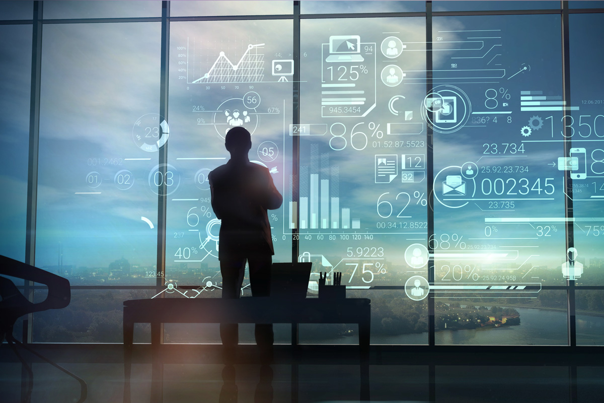 Silhouette analyzing complex data visualizations on futuristic transparent screens