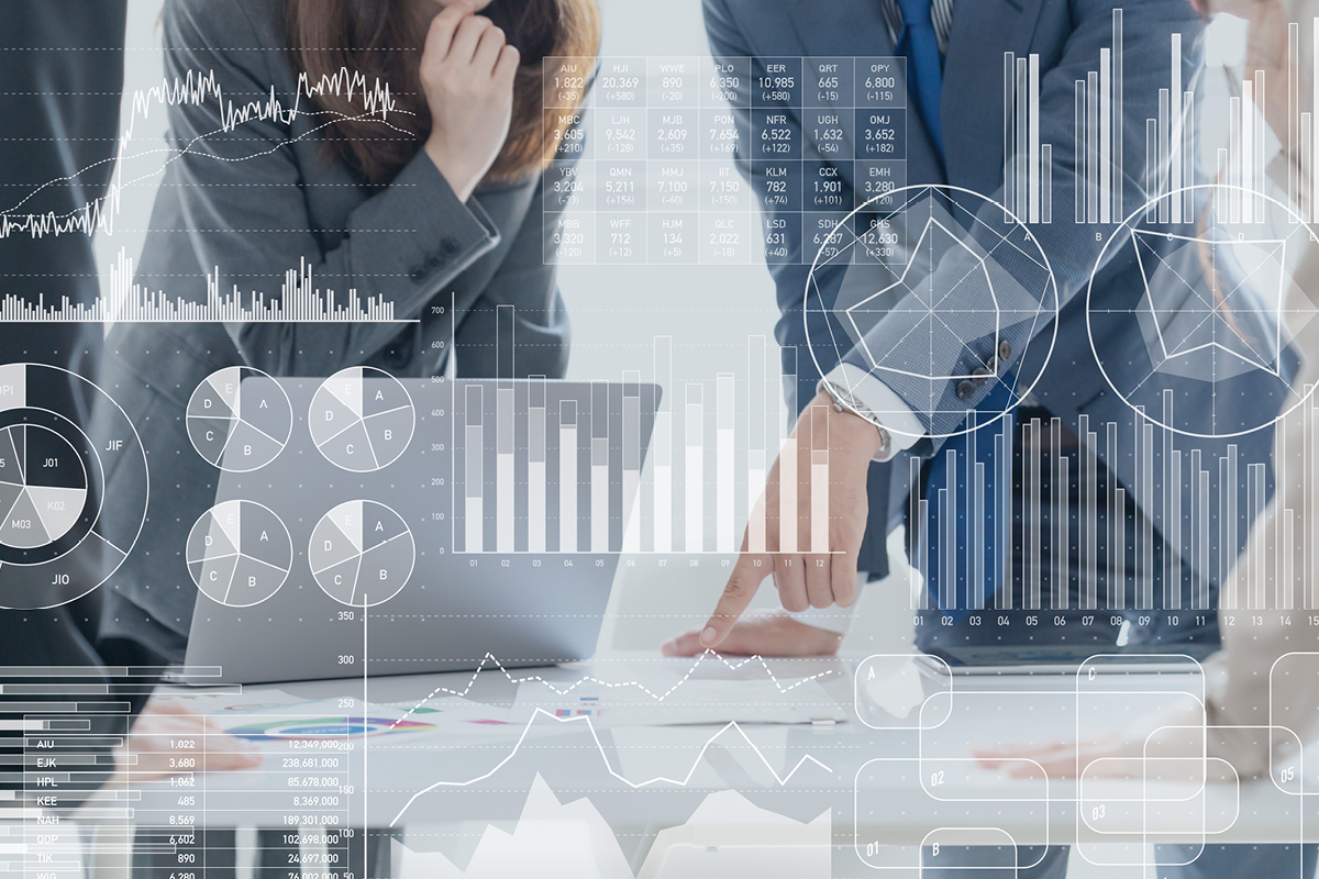 Business professionals analyzing financial data with complex charts and graphs