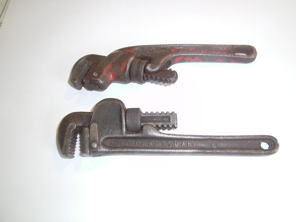 Two rusty Craftsman pipe wrenches on a white background