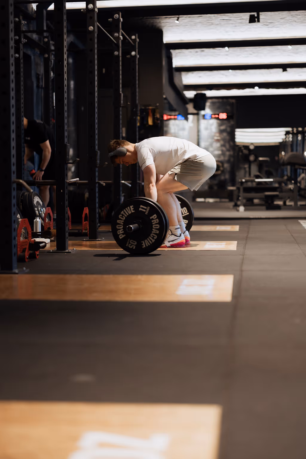 Teen training with barbell in gym at ONE DZ Derby youth membership zone