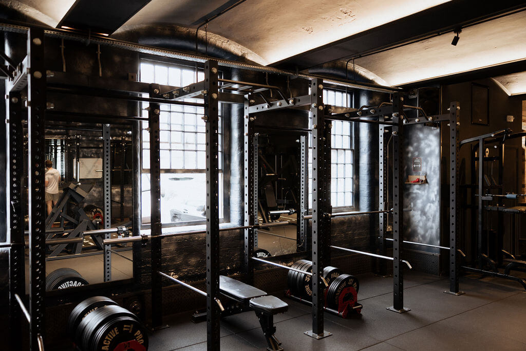 Strength training area with squat racks at ONE|DZ Gym in Derby