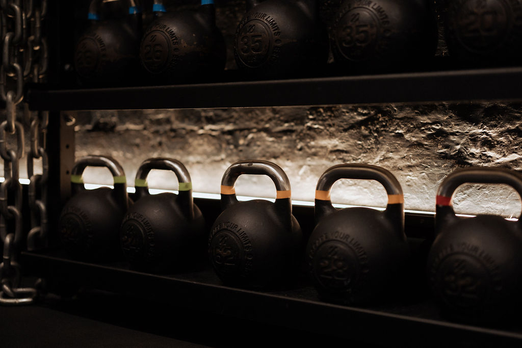 A Pilates class in session with participants using reformers.