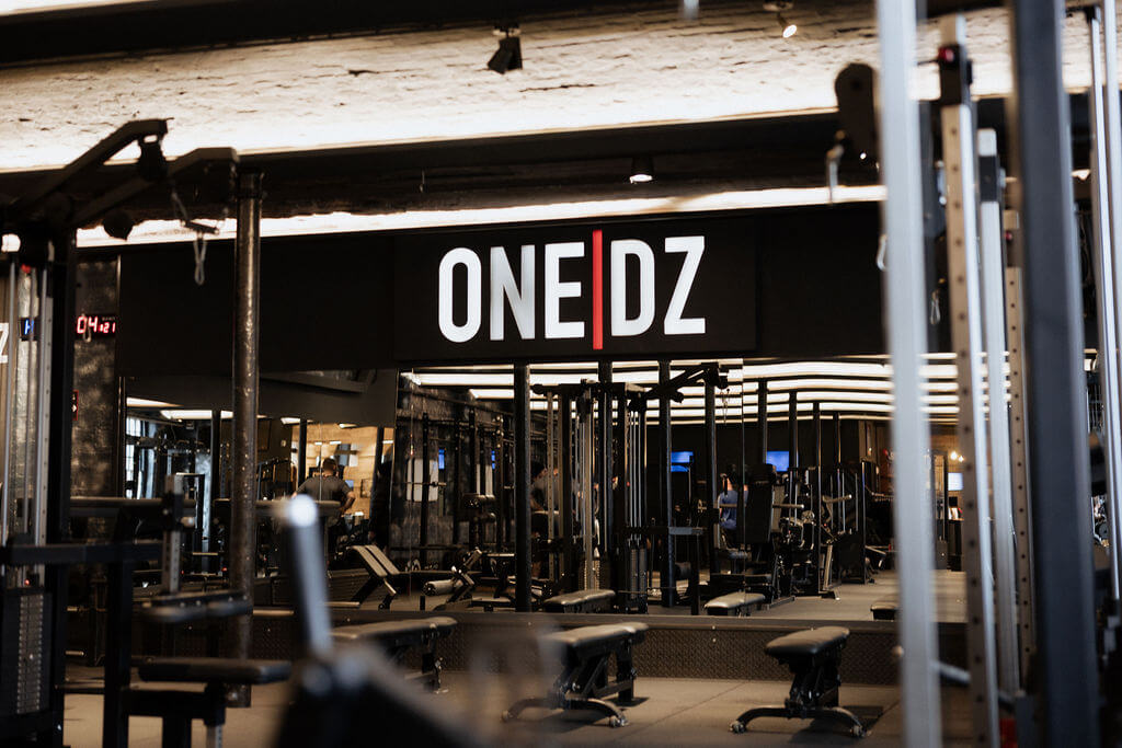 Interior view of ONE|DZ Gym in Derby with visible logo above training area
