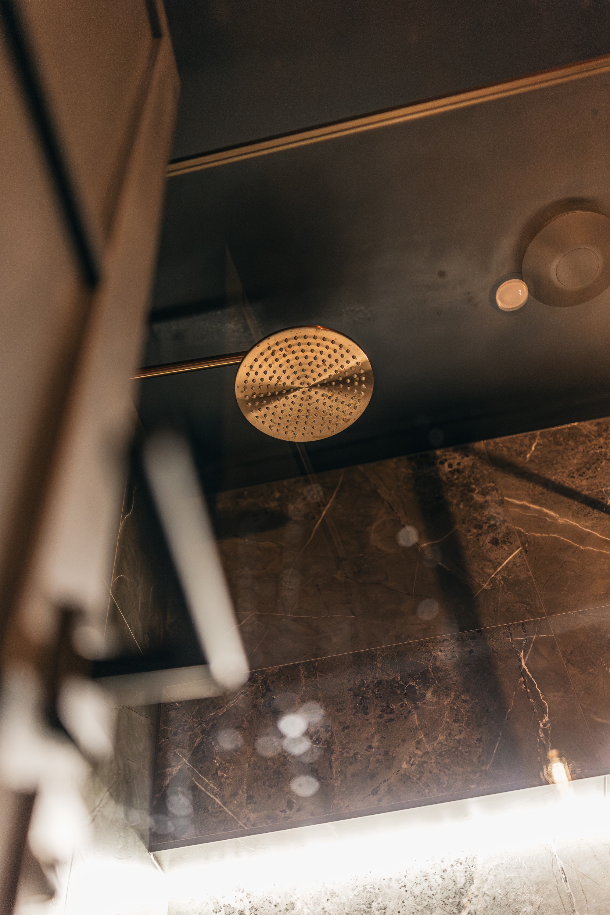 Close-up of luxury rainfall shower at ONE|DZ Gym Derby recovery and sauna facilities.