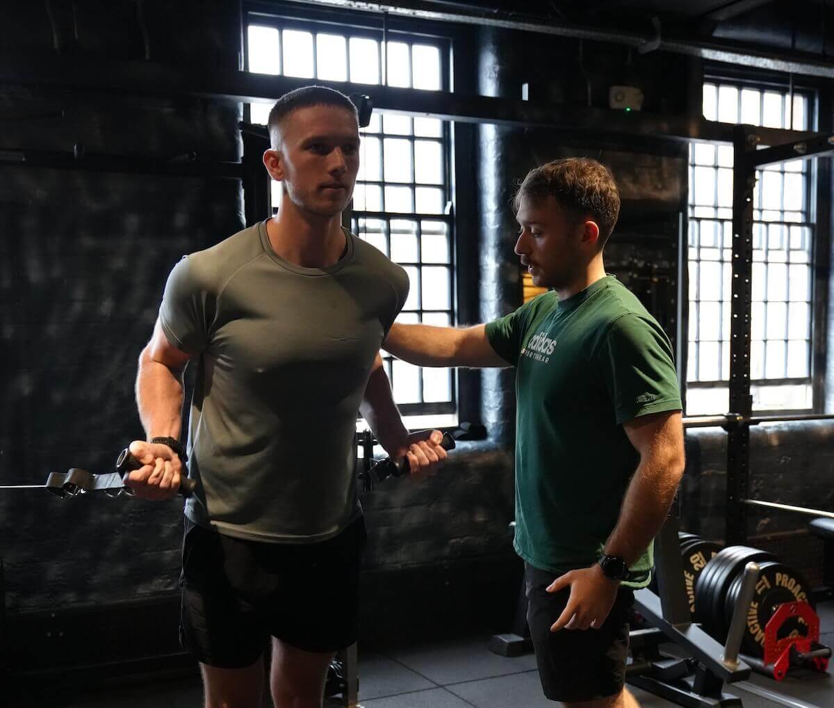 Male client working on cable biceps during personal training session at ONE|DZ Gym Derby