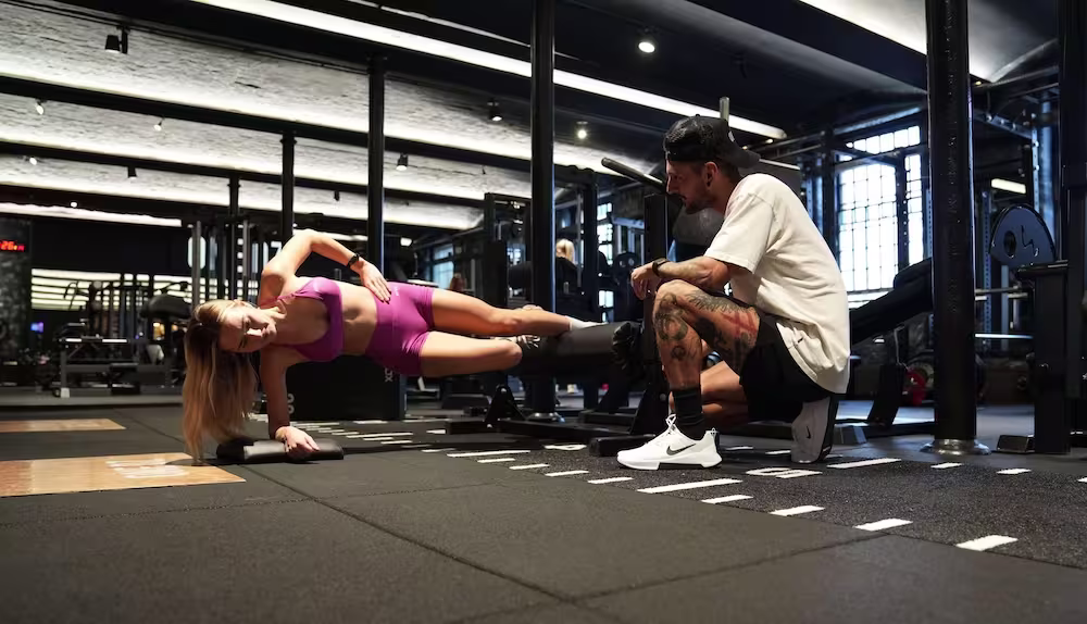 Female client doing Copenhagen with coach support at ONE DZ Gym in Derby during personal training session