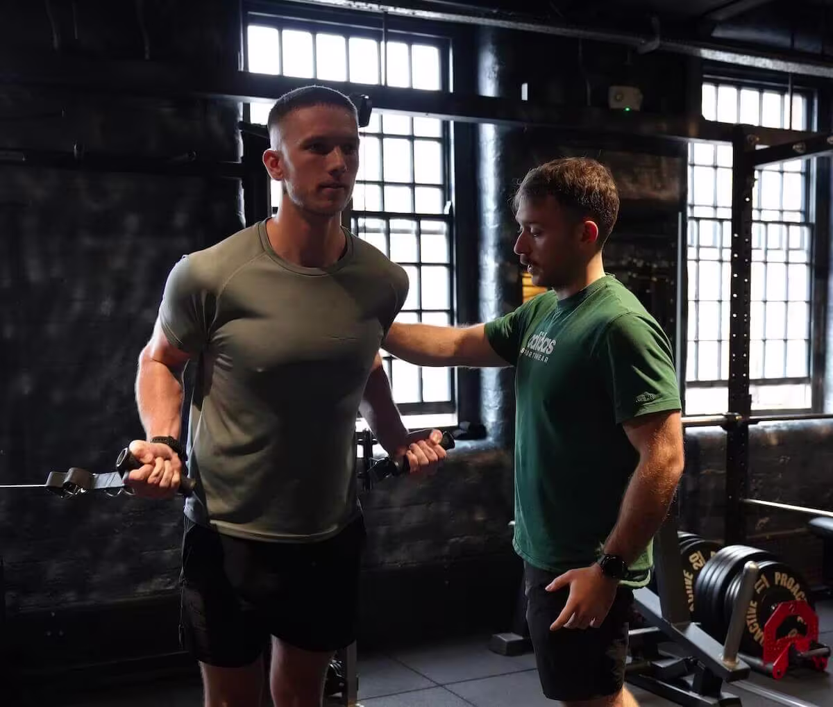 Male client working on cable biceps during personal training session at ONE|DZ Gym Derby