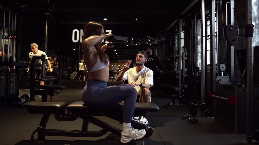 Female client doing lat rows during PT session at ONE|DZ strength gym