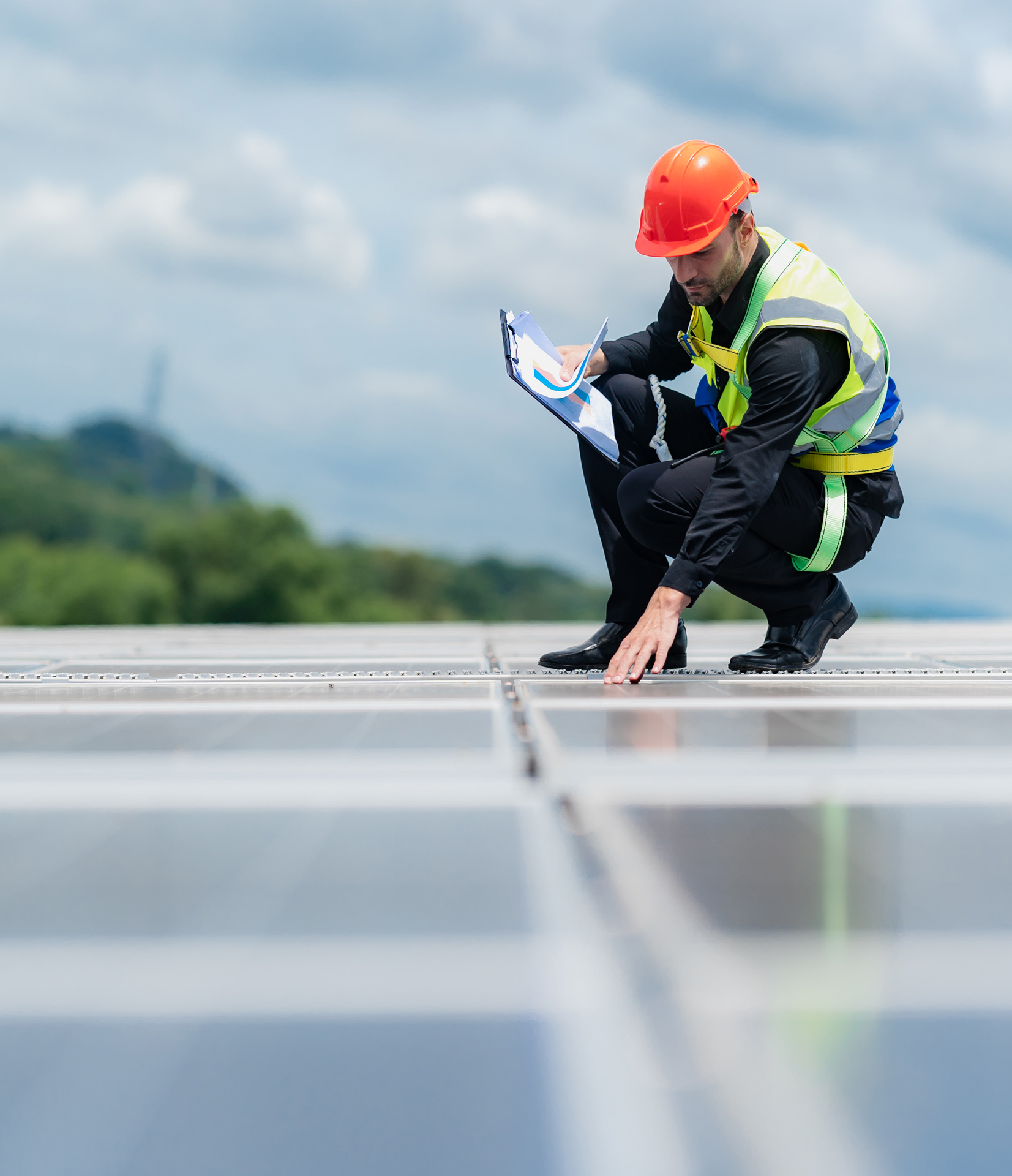 worker in hard hat and safety gear inspecting site for quality assurance