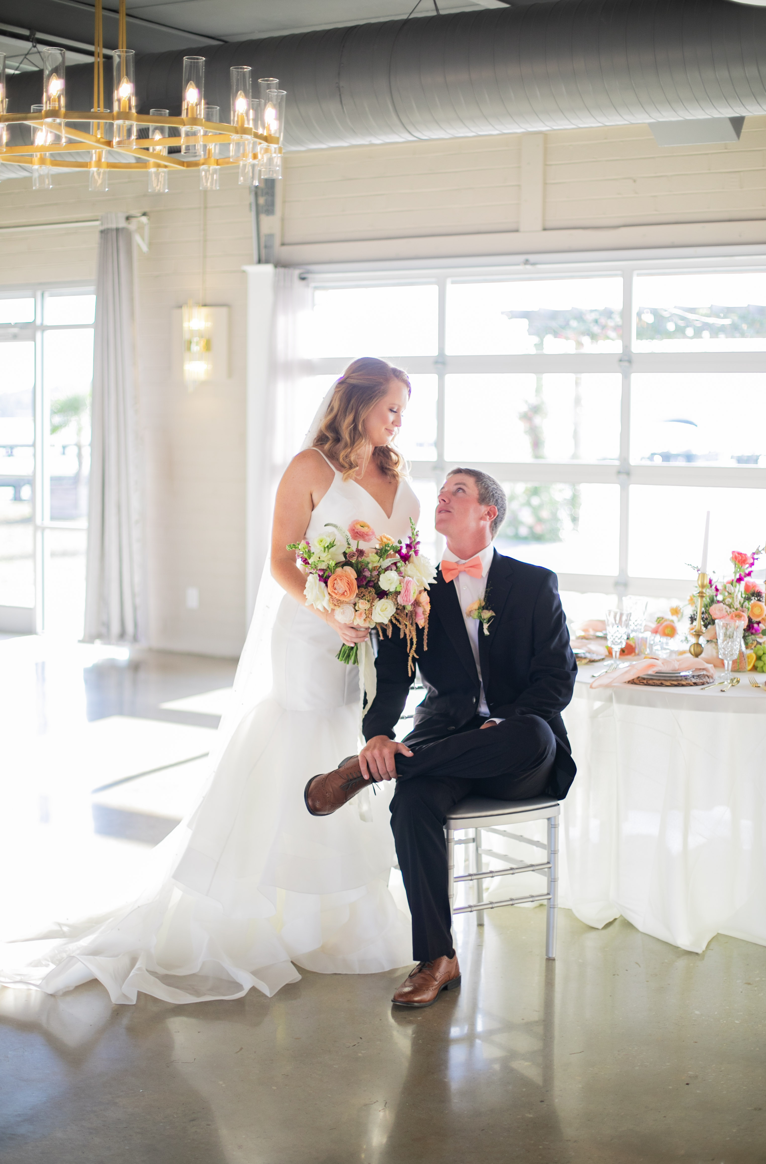 Bride in white dress and groom in black suit at elegant wedding reception