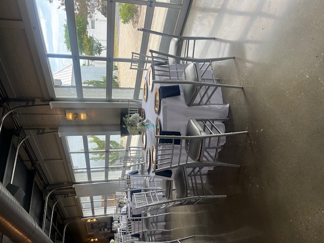 Elegant wedding reception setup with silver chairs and white tablecloth