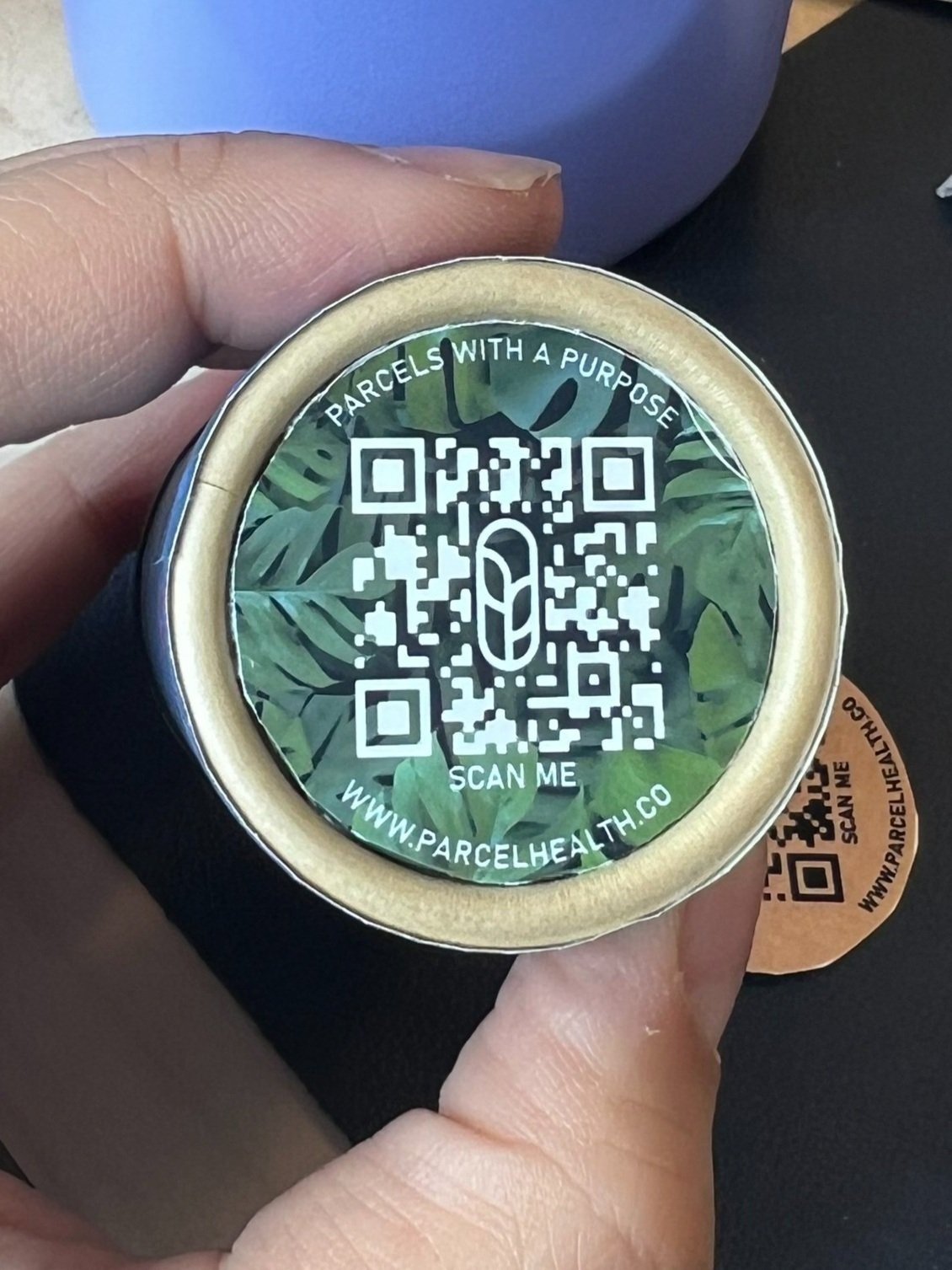 Parcel Health mock up of the bottom of a customized, four color, paper pill bottle with beautiful design and QR code on the bottom to showcase at NACDS STE in Boston 2024