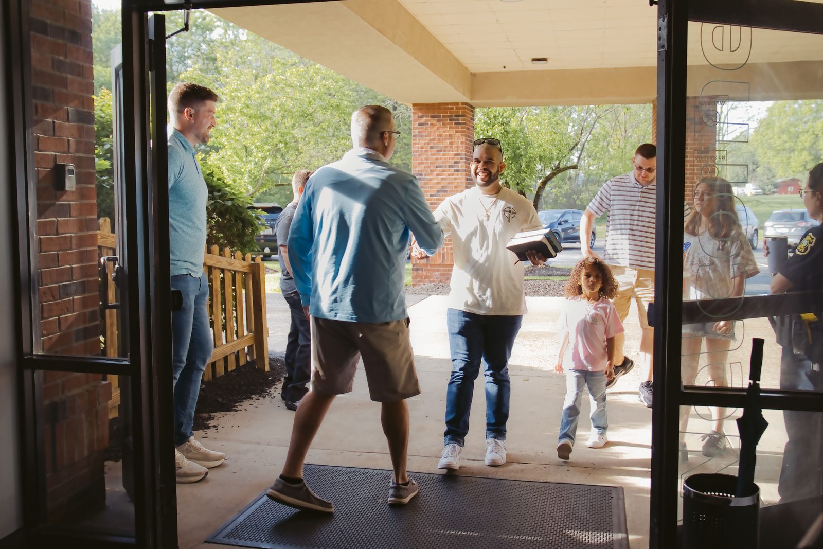 Believers Church volunteers welcoming guests at the front doors