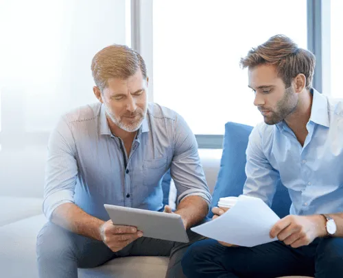 Lifestyle two men meeting blue shirt tablet paper