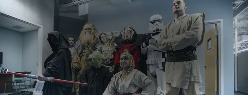 People dressed as characters from Star Wars: The Force Awakens, set against a dramatic space backdrop.