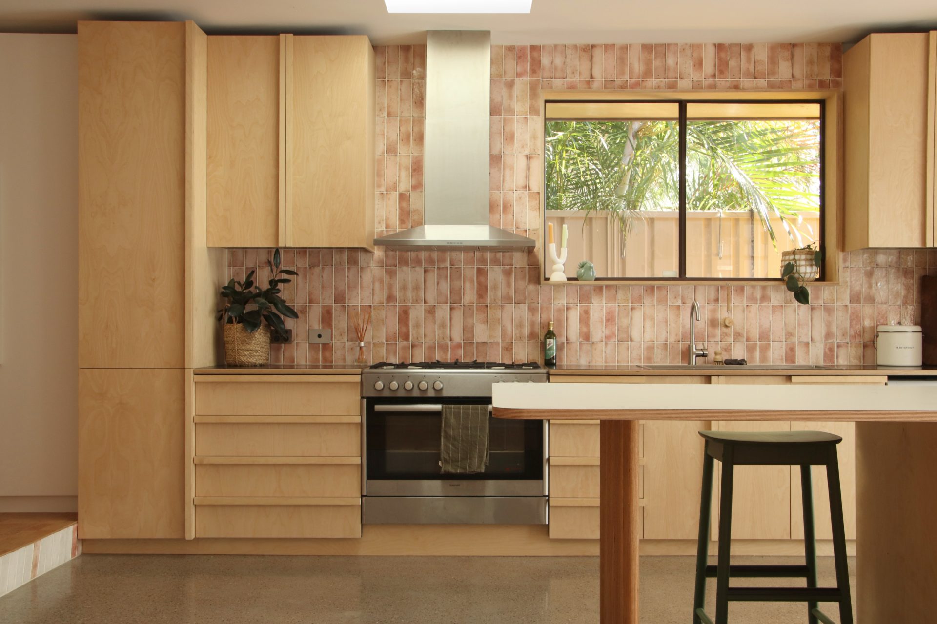 Timber style kitchen with brown tile walls and a timber high benchtop