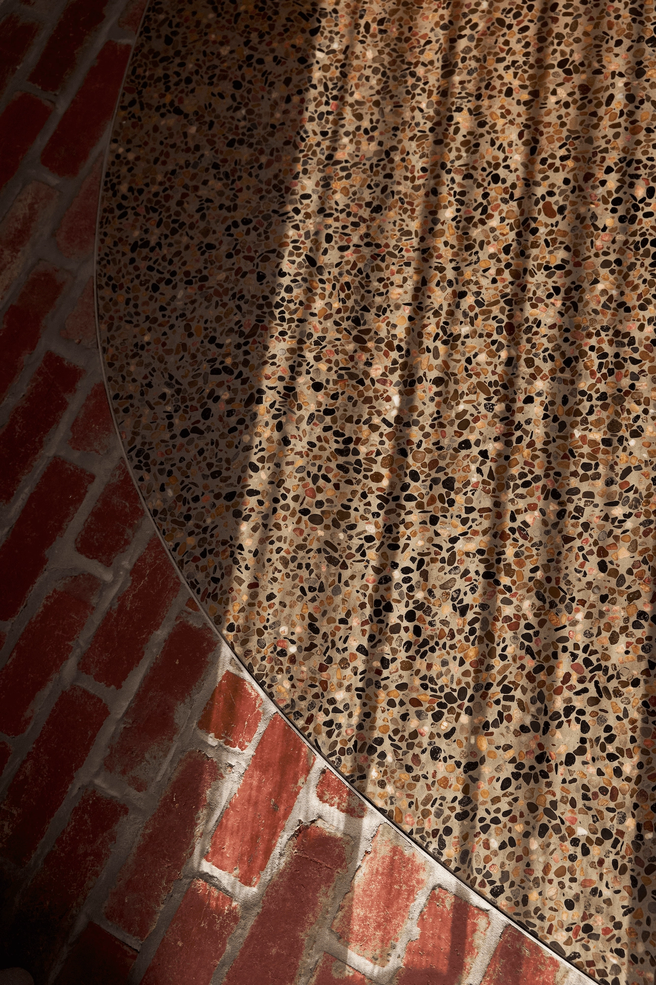 Close up detail shot showing shadows across a brick and stone floor