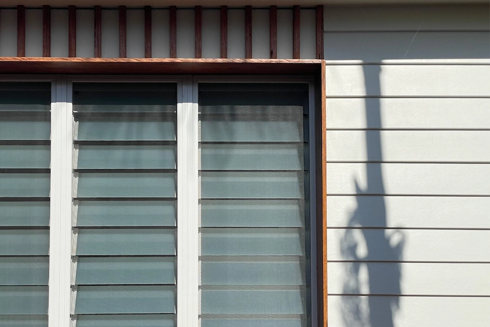 Close up shot of outside of house in Newcastle with wood panelling and panelled windows