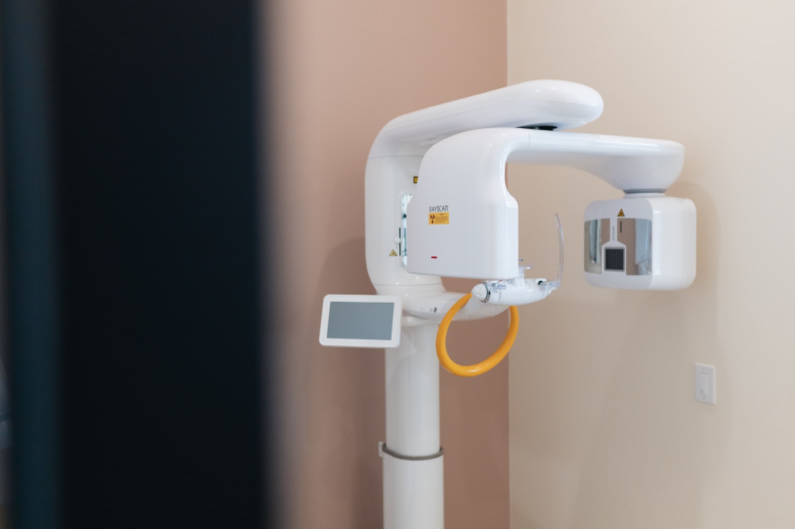 Panoramic dental X-ray machine mounted in modern dental treatment room