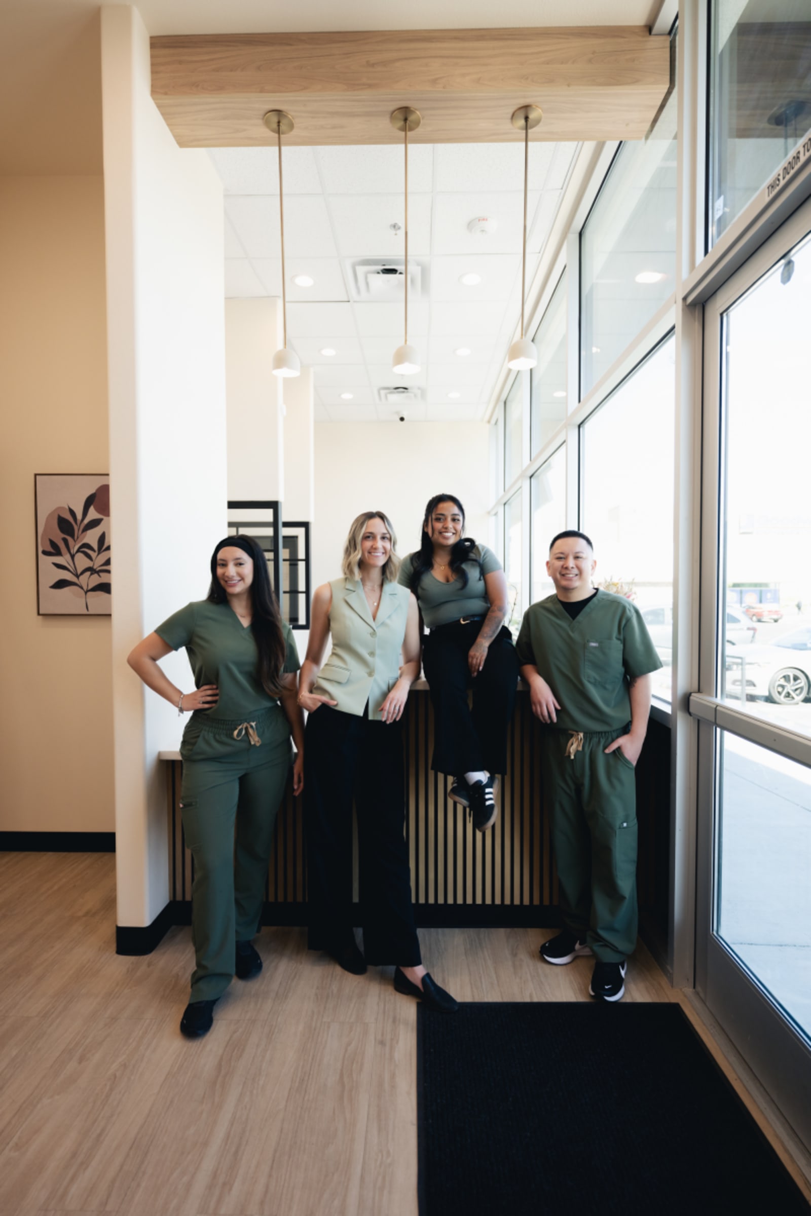 Bloom Dental Co team of four dental professionals standing together in modern office