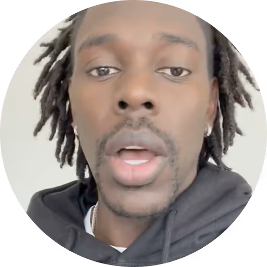 Person in black hoodie looking directly at camera