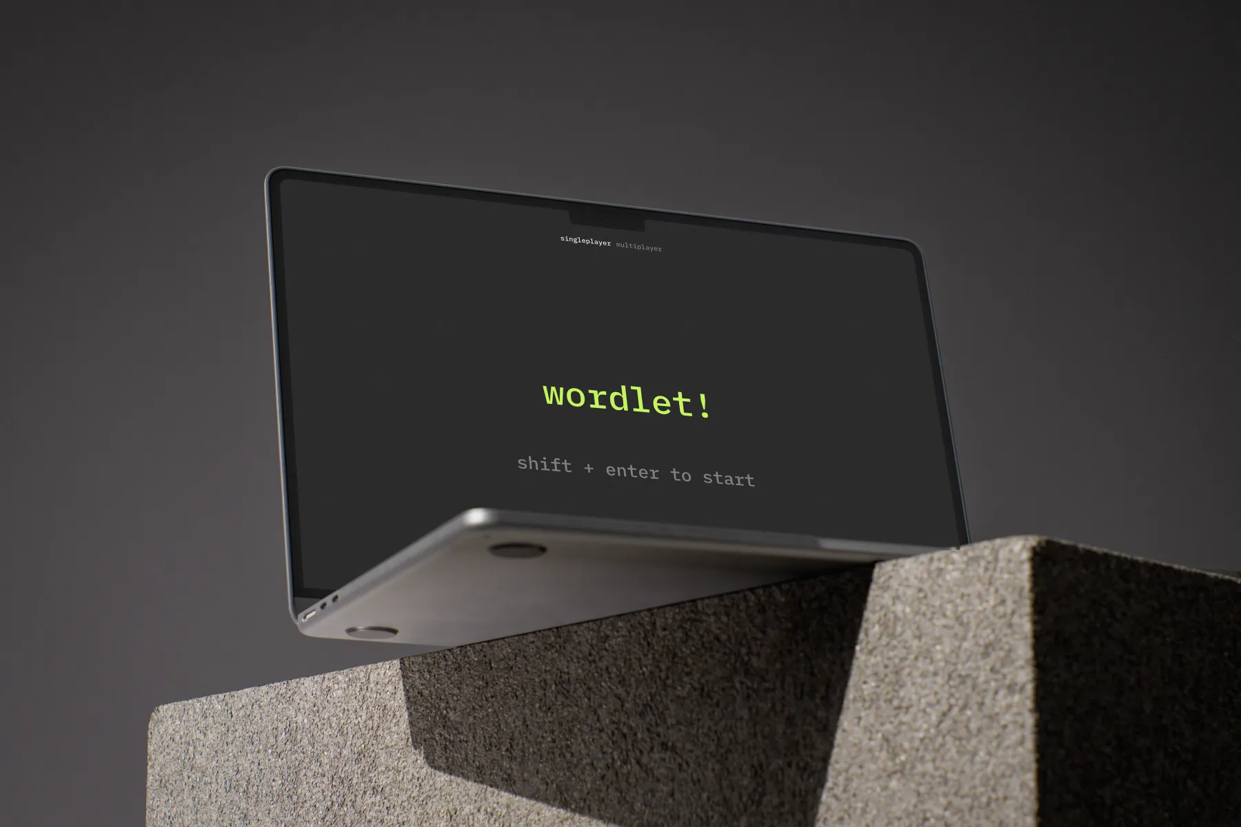 A mockup of wordlet. Depicted is a laptop stylistically photographed on a concrete block with the wordlet main page on the screen.