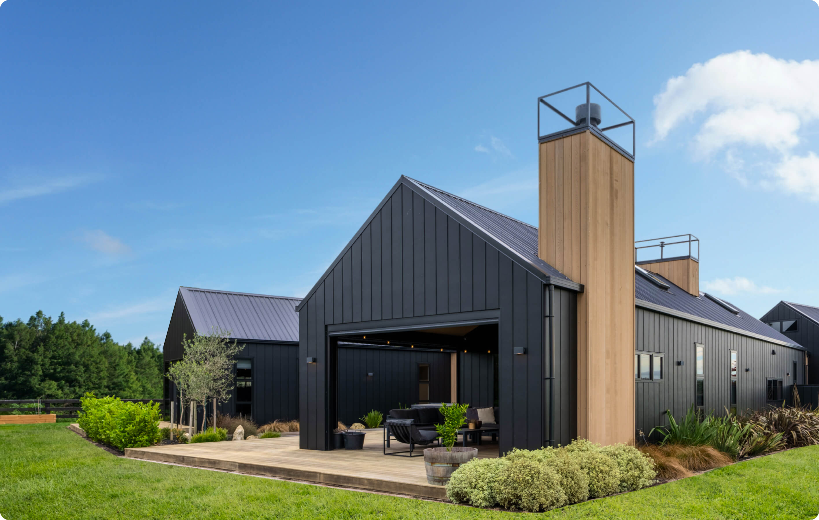 Two houses, sunny day, blue skies, lots of greenery with open plan housing