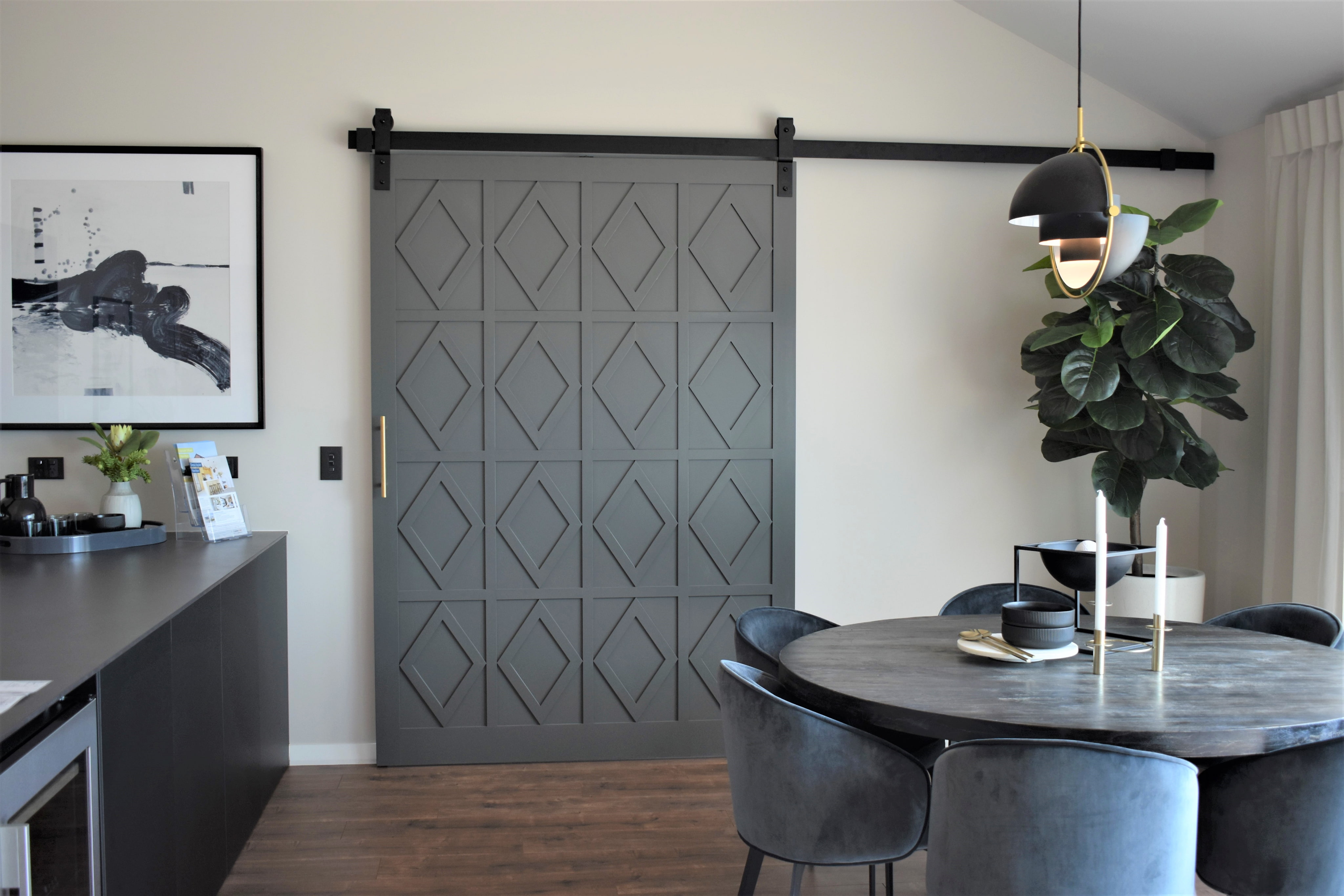 A dark sliding barn door partially 
