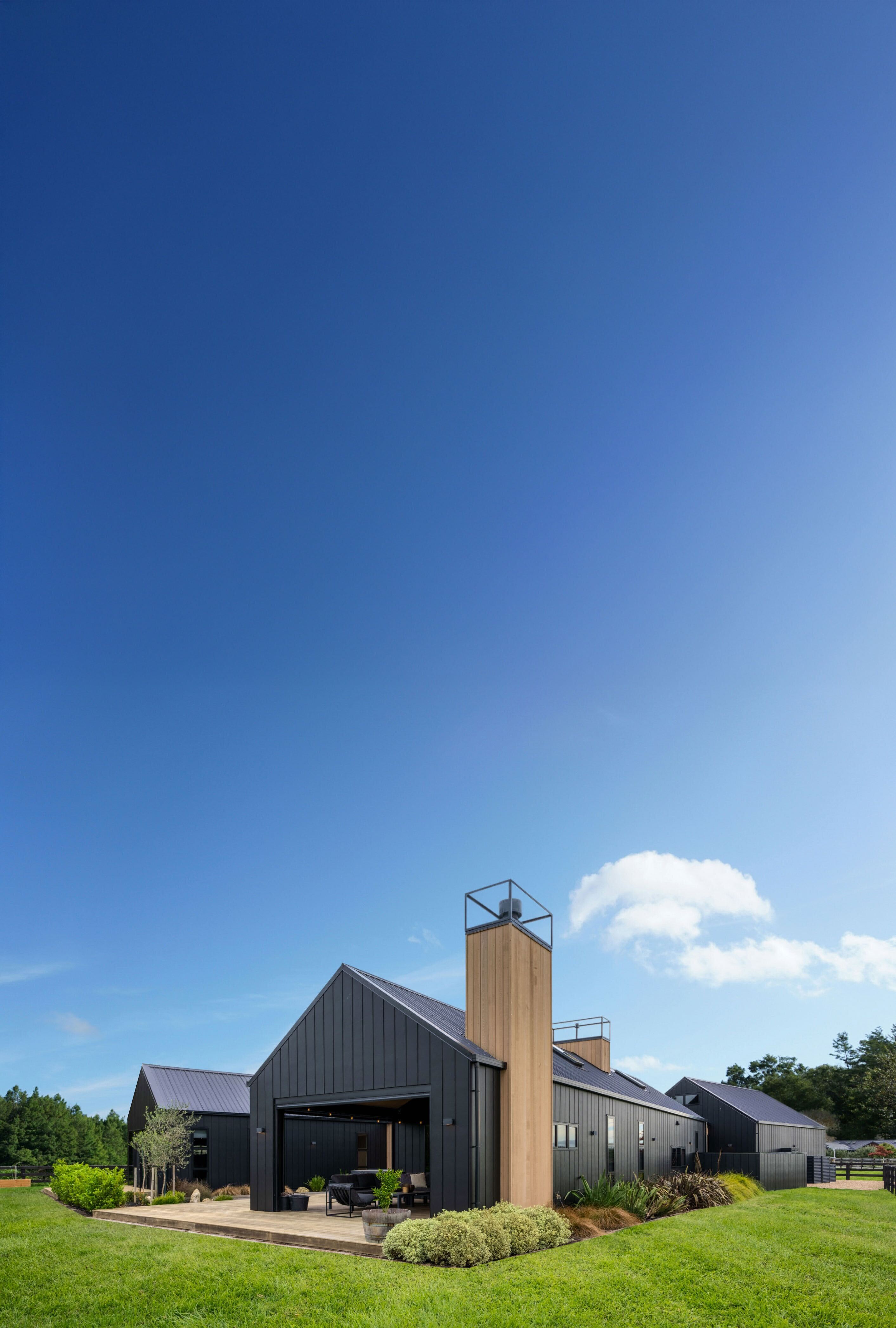 Two houses, sunny day, blue skies, lots of greenery with open plan housing