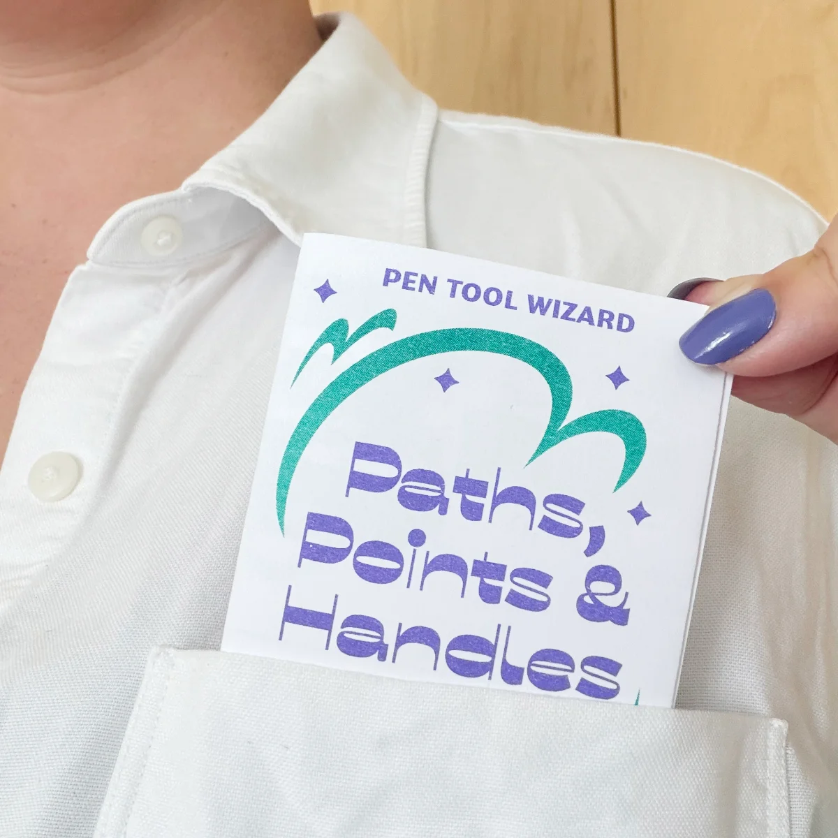 A close up on a person wearing a white pocketed shirt and slipping the small booklet into the pocket