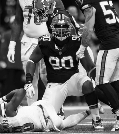 Football player making a clutch catch under pressure – symbolizing the precision and drive Red Envelope Sports Agency looks for in rising talent.