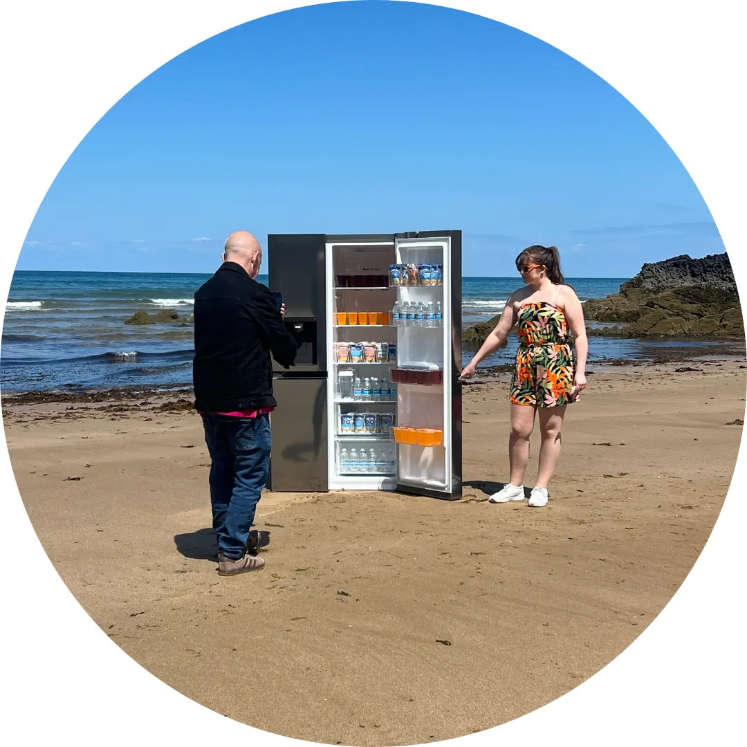 Filming with a fridge on the beach