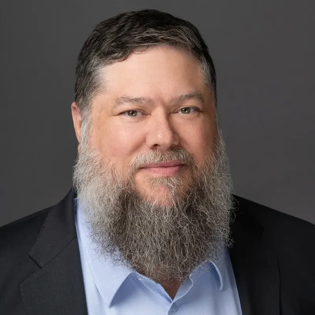 Portrait of Critical Tilt’s president in suit with beard