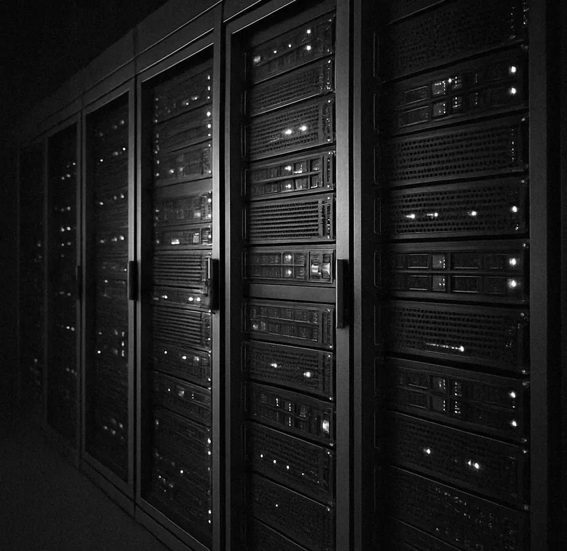 Dark server room with glowing equipment and connected cables