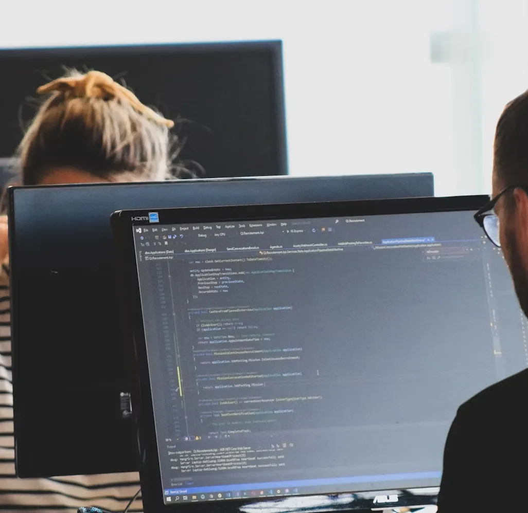 Developers working side by side on code implementation