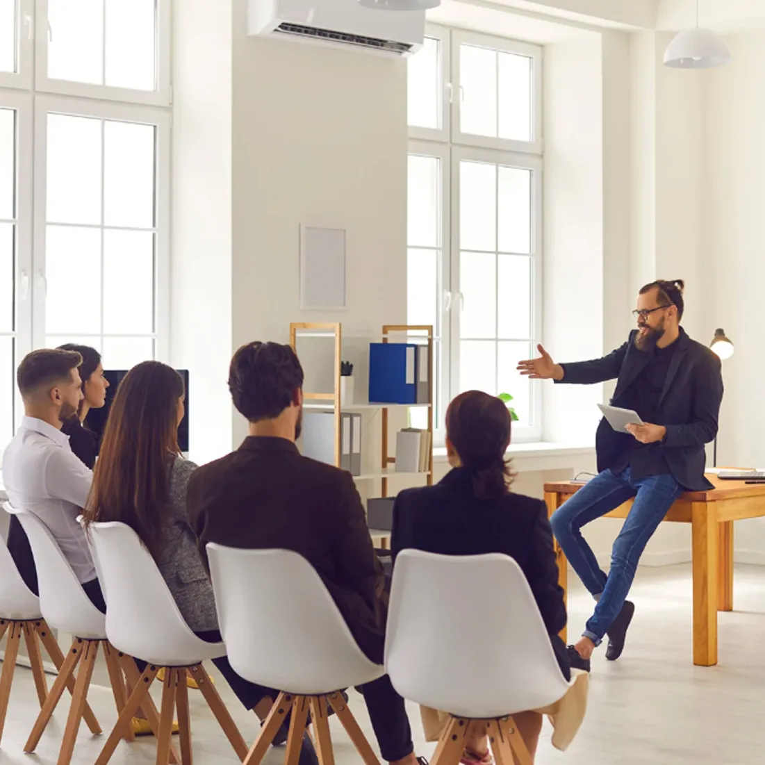 Startup-style leader presenting to small engaged team