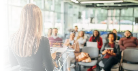 Business presentation with seated audience in modern office