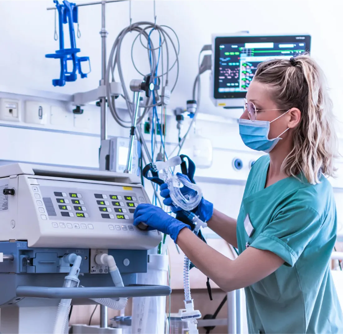 Nurse operating high-tech medical equipment in clinical setting