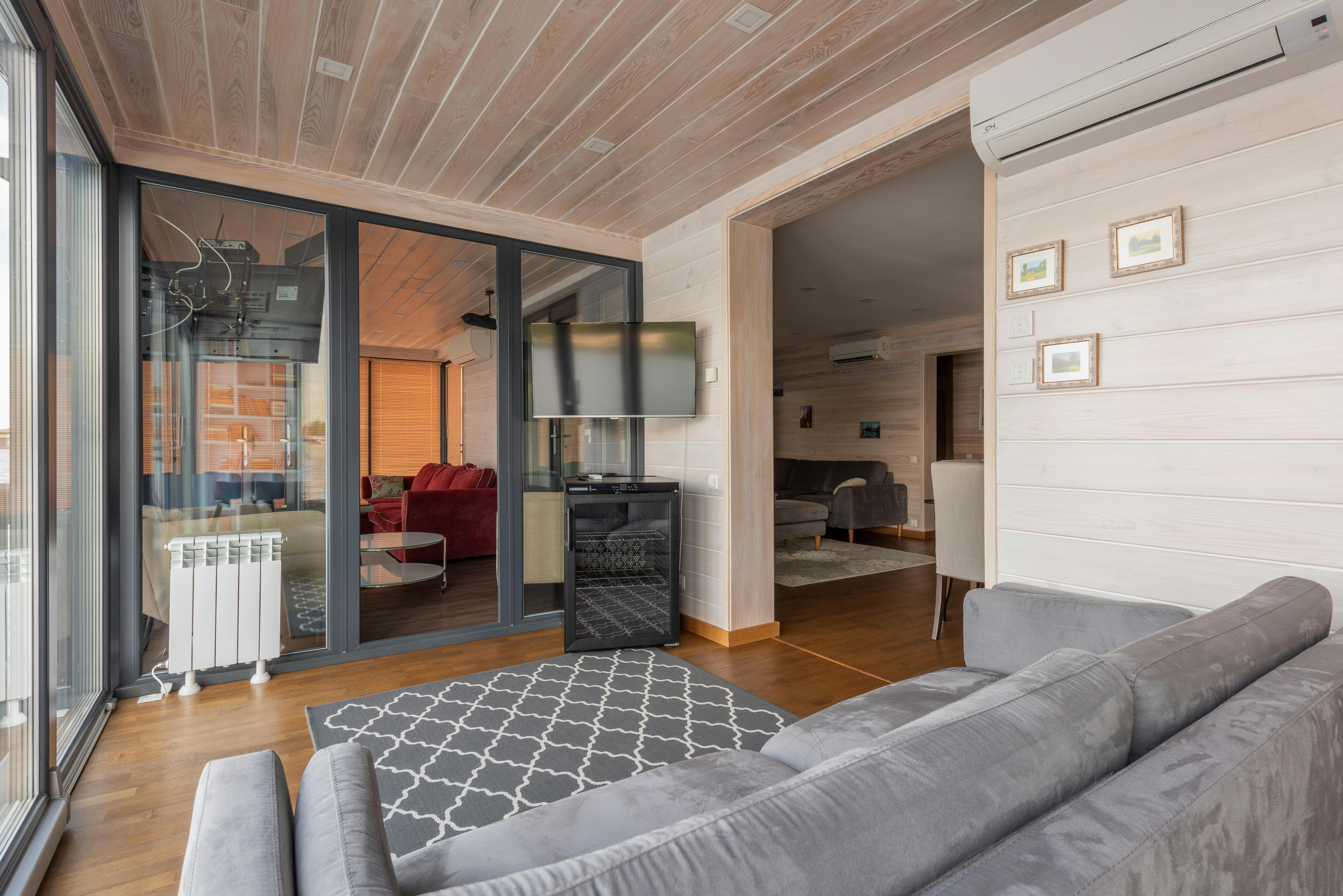 a log cabin living room with an air con unit above the sofa