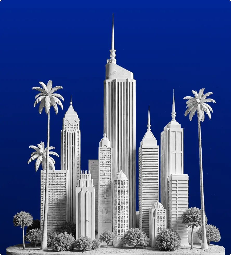 White architectural model of a city skyline with tall buildings and palm trees against a deep blue background.