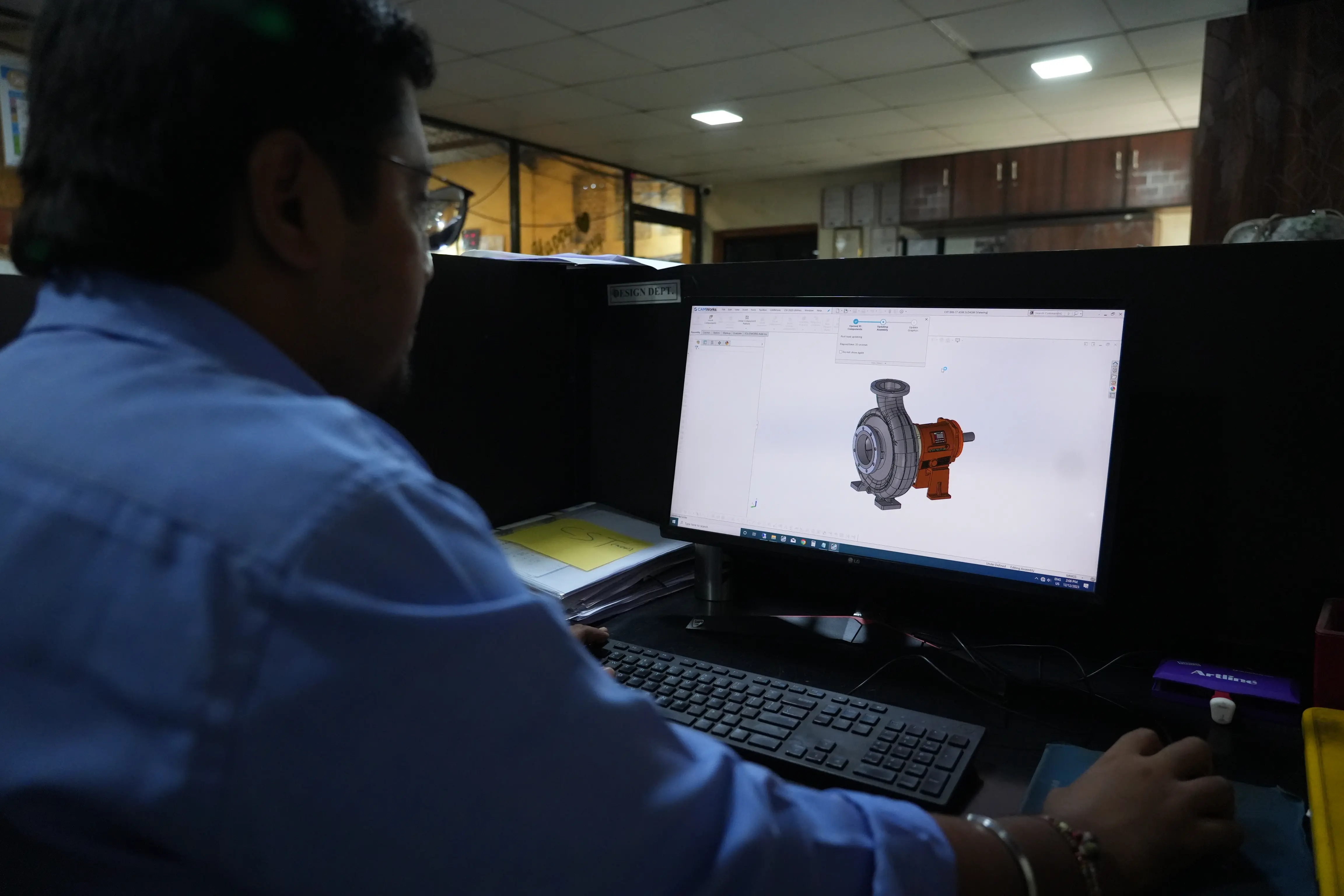 Engineer designing a custom centrifugal pump using CAD software