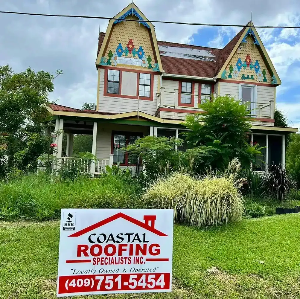 coastal roofing sign in front of a home