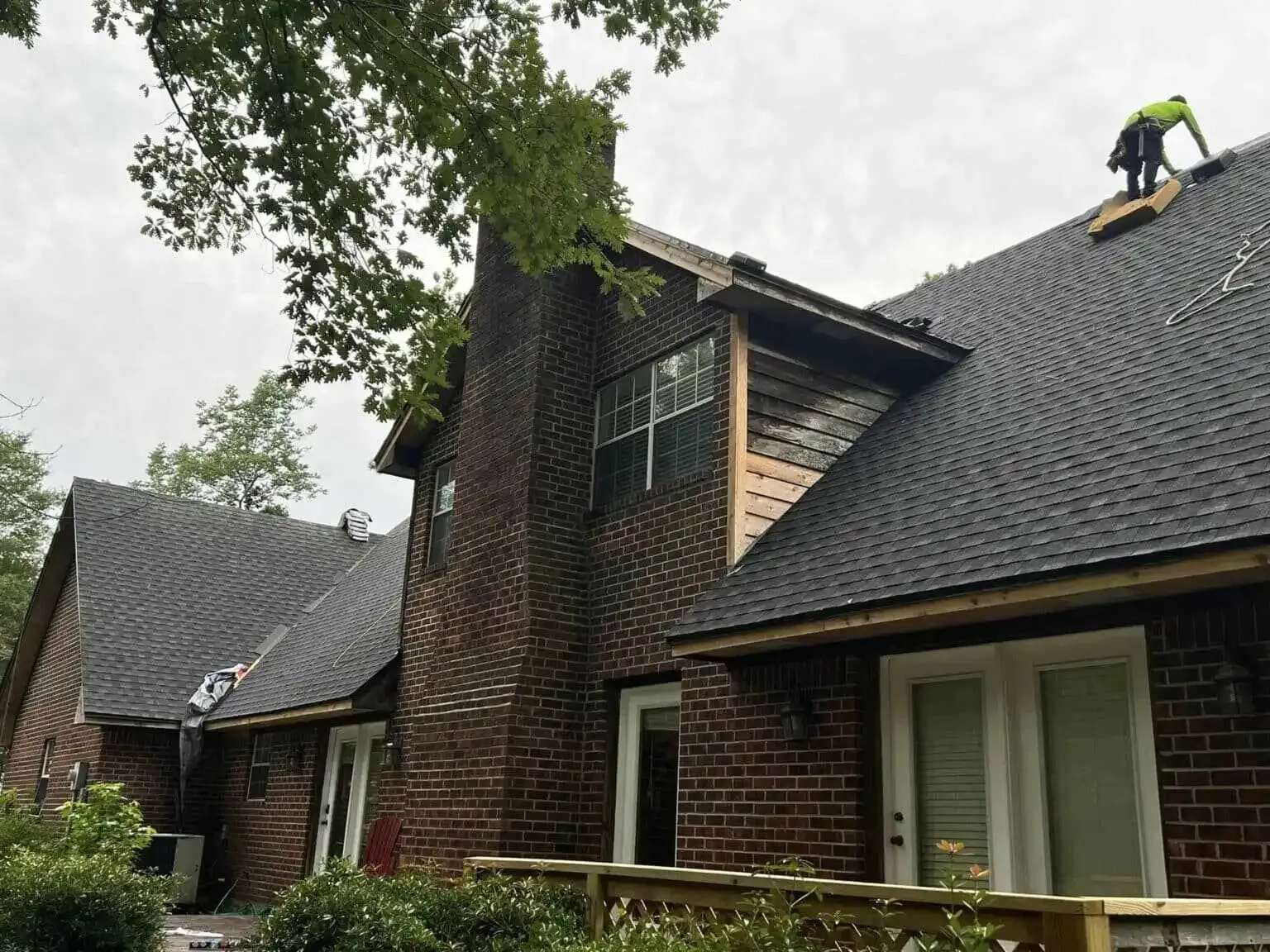 man performing roof repairs