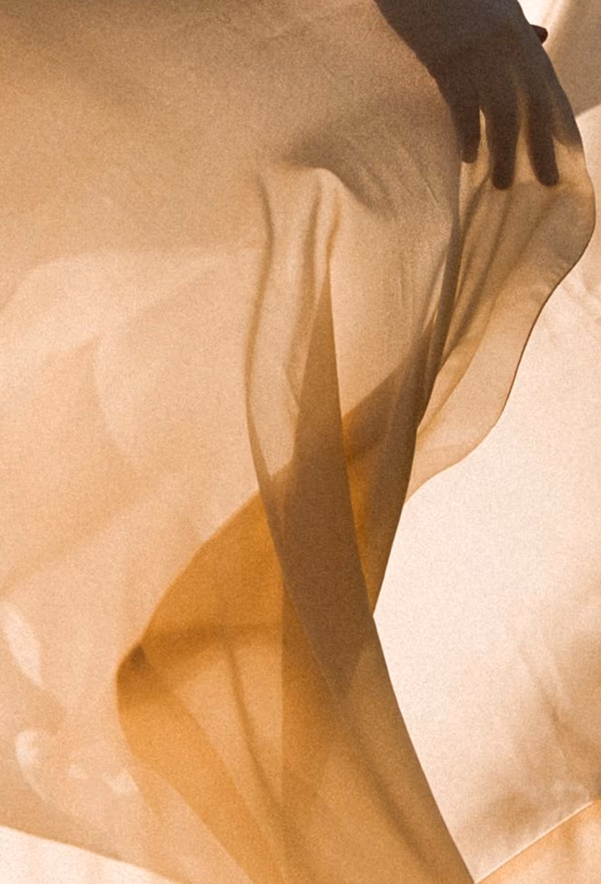 Light brown piece of clothing with a hand peeking