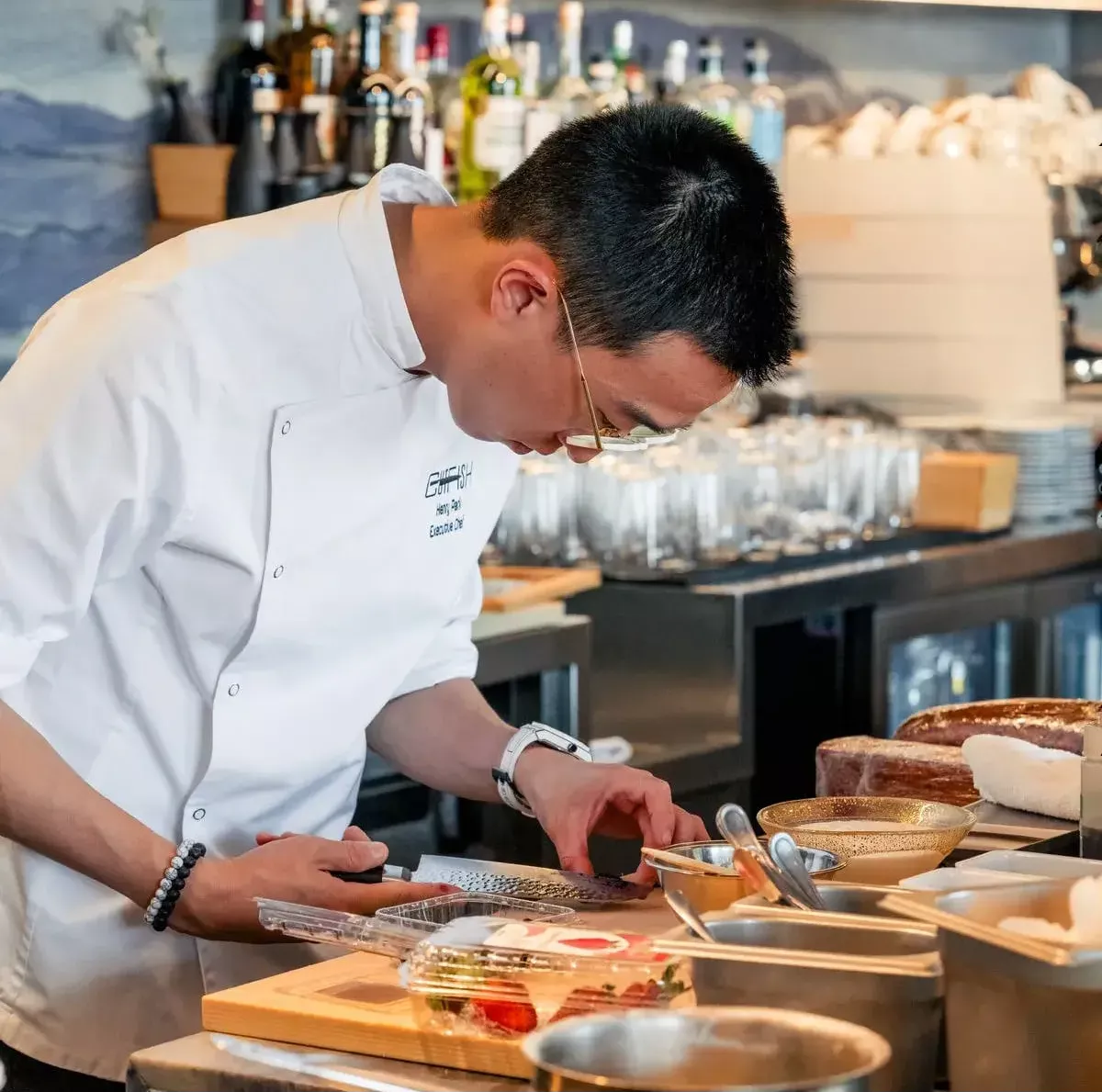Chef Henry Park plating a dish