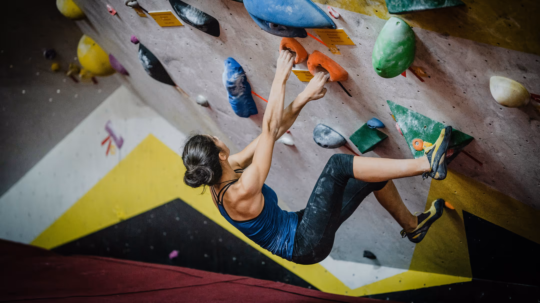 Climber hanging on boulder wall