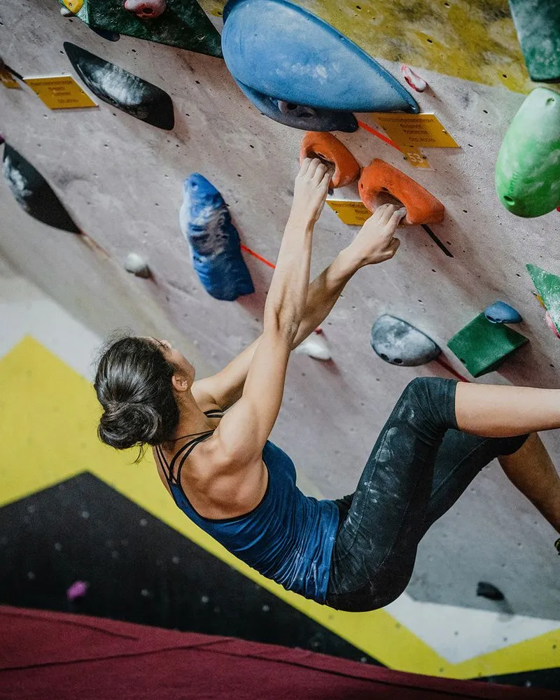 Climber hanging on boulder wall