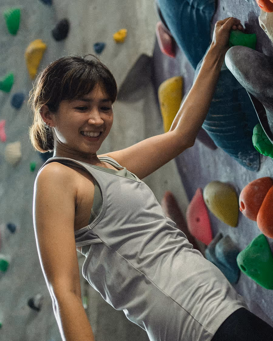 Climber smiling on rock wall
