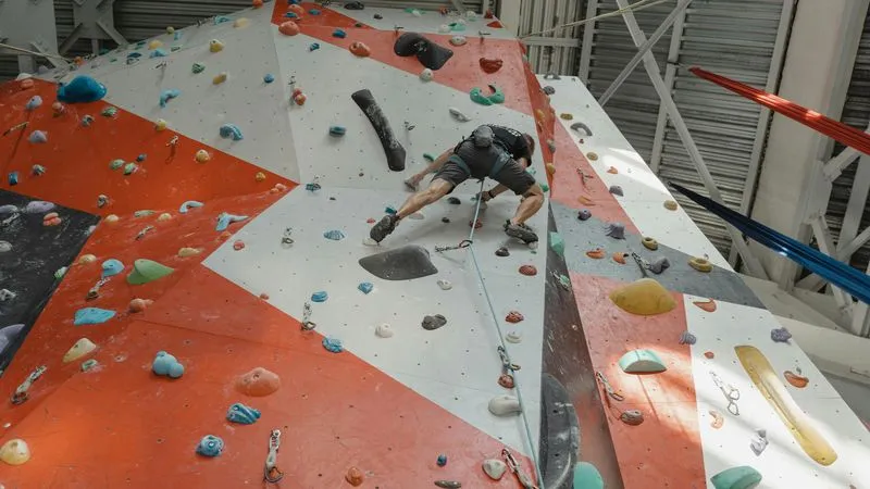 Climber on red and white wall