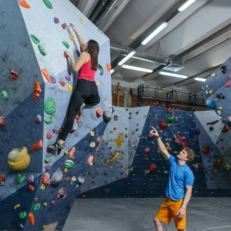 Climber assisting climber with route